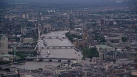 5.5K aerial stock footage of London Eye and bridges over River Thames, Big Ben and British Parliament, London, England, twilight Aerial Stock Footage | AX116_096