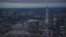 5.5K aerial stock footage of Tower Bridge spanning River Thames near The Shard, London, England, night Aerial Stock Footage | AX116_103E