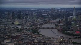 5.5K aerial stock footage of bridges spanning River Thames near skyscrapers, London, England, night Aerial Stock Footage | AX116_105E