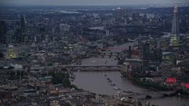 5.5K aerial stock footage a view of bridges, River Thames, tall skyscrapers and cityscape, London, England, night Aerial Stock Footage | AX116_108