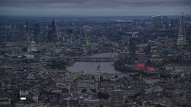 5.5K aerial stock footage of skyscrapers and vast cityscape near bridges over River Thames, London, England, night Aerial Stock Footage | AX116_110E