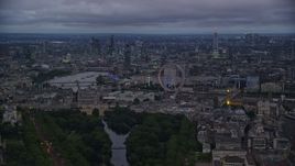 5.5K aerial stock footage skyscrapers seen from near London Eye and Big Ben by River Thames, London, England, night Aerial Stock Footage | AX116_115