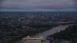 5.5K aerial stock footage wide view of London cityscape and River Thames seen from Albert Bridge, London, England, night Aerial Stock Footage | AX116_130E