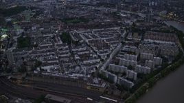 5.5K aerial stock footage tilt from Chelsea Bridge and River Thames to reveal apartments and cityscape, London, England, night Aerial Stock Footage | AX116_137E