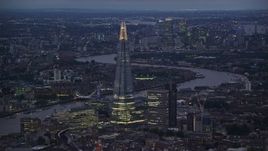 5.5K aerial stock footage of a view of The Shard skyscraper and River Thames, London, England, night Aerial Stock Footage | AX116_145E
