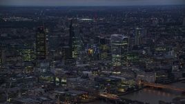 5.5K aerial stock footage of flying by skyscrapers in Central London, London, England, night Aerial Stock Footage | AX116_147E