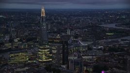 5.5K aerial stock footage of The Shard skyscraper near the Tower Bridge, London, England, night Aerial Stock Footage | AX116_150