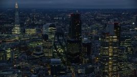 5.5K aerial stock footage of The Gherkin skyscraper, seen from near Heron Tower, London, England, night Aerial Stock Footage | AX116_166E