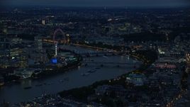 5.5K aerial stock footage of approaching bridges spanning River Thames and London Eye, London, England, night Aerial Stock Footage | AX116_174