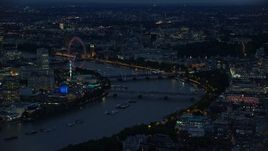 5.5K aerial stock footage of an approach to London Eye by bridges over River Thames, London, England, night Aerial Stock Footage | AX116_175