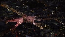 5.5K aerial stock footage of flying by the bright lights of Piccadilly Circus, London, England, night Aerial Stock Footage | AX116_180
