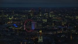 5.5K aerial stock footage of the London Eye, Big Ben and distant skyscrapers, London, England, night Aerial Stock Footage | AX116_195E