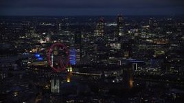 5.5K aerial stock footage of London Eye, Big Ben and skyscrapers in the background, London, England, night Aerial Stock Footage | AX116_196