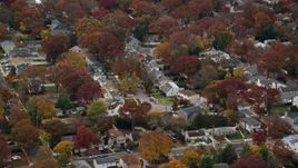 5.5K aerial stock footage of circling homes in a suburban neighborhood in Autumn, Merrick, New York Aerial Stock Footage | AX117_019E