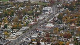 5.5K aerial stock footage of homes and shops on a Main Street in Autumn, Bellmore, New York Aerial Stock Footage | AX117_041