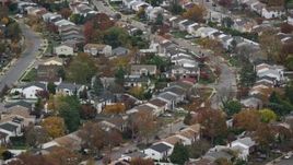 5.5K aerial stock footage of an orbit of suburban homes in Autumn, Bellmore, New York Aerial Stock Footage | AX117_044E