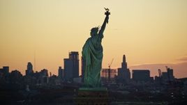 5.5K aerial stock footage orbit back of the Statue of Liberty at sunrise, New York Aerial Stock Footage | AX118_042E
