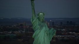 5.5K aerial stock footage orbit Statue of Liberty at sunrise, with New York City in the background Aerial Stock Footage | AX118_046E