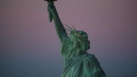 5.5K aerial stock footage of a profile view of the Statue of Liberty at sunrise, New York Aerial Stock Footage | AX118_060