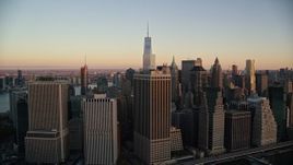 5.5K aerial stock footage of flying by Lower Manhattan skyscrapers at sunrise in New York City Aerial Stock Footage | AX118_076E