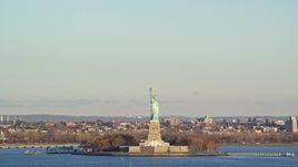 5.5K aerial stock footage of Statue of Liberty and hazy sky at sunrise in New York Aerial Stock Footage | AX118_136