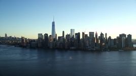 5.5K aerial stock footage of approaching the Lower Manhattan skyline by the Hudson at sunrise in New York City Aerial Stock Footage | AX118_151