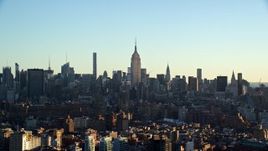 5.5K aerial stock footage of the Empire State Building and skyscrapers in Midtown at sunrise in New York City Aerial Stock Footage | AX118_157
