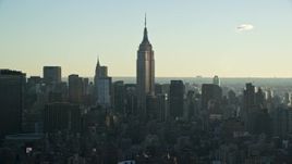5.5K aerial stock footage of the Empire State Building at sunrise in Midtown, New York City Aerial Stock Footage | AX118_162