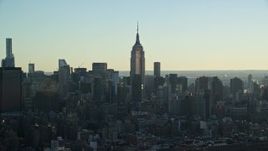 5.5K aerial stock footage of a wide orbit of the Empire State Building in Midtown at sunrise, New York City Aerial Stock Footage | AX118_163E