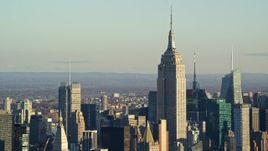 5.5K aerial stock footage of the Empire State Building towering over Midtown at sunrise in New York City Aerial Stock Footage | AX118_173E