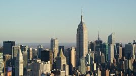 5.5K aerial stock footage of approaching the Empire State Building towering over Midtown at sunrise in New York City Aerial Stock Footage | AX118_175E