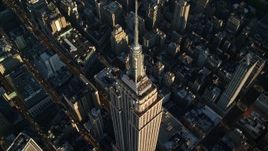 5.5K aerial stock footage approach and tilt to bird's eye of the Empire State Building at sunrise in New York City Aerial Stock Footage | AX118_181E