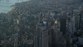 5.5K aerial stock footage of orbiting the top of the Empire State Building at sunrise in New York City Aerial Stock Footage | AX118_204