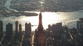 5.5K aerial stock footage of an orbit of the top spire of the Empire State Building at sunrise in New York City Aerial Stock Footage | AX118_205