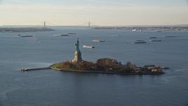 5.5K aerial stock footage of an orbit of Statue of Liberty at sunrise in New York Aerial Stock Footage | AX118_216E