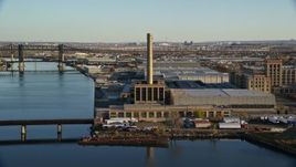 5.5K aerial stock footage of riverfront factory at sunrise in Kearny, New Jersey Aerial Stock Footage | AX118_227