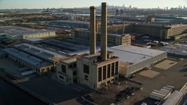 5.5K aerial stock footage of orbiting a riverfront factory at sunrise in Kearny, New Jersey Aerial Stock Footage | AX118_228