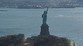 5.5K aerial stock footage of an orbit around the back of the Statue of Liberty in Autumn, New York Aerial Stock Footage | AX119_011E