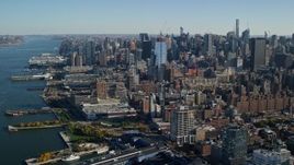 5.5K aerial stock footage of piers and riverfront buildings in Chelsea and skyscrapers in Midtown, New York City Aerial Stock Footage | AX119_024
