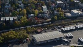 5.5K aerial stock footage of tracking commuter train in Autumn, Yonkers, New York Aerial Stock Footage | AX119_067E