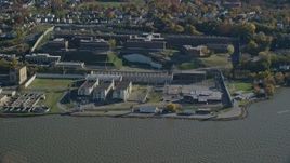 5.5K aerial stock footage orbit Sing Sing Prison in Autumn, seen from the river, Ossining, New York Aerial Stock Footage | AX119_121E