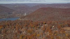 5.5K aerial stock footage of forest in Autumn by the Hudson River, Westchester County, New York Aerial Stock Footage | AX119_149