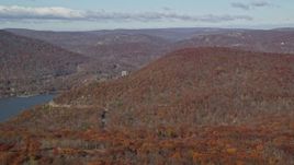 5.5K aerial stock footage of flying by forest in Autumn by the Hudson River, Westchester County, New York Aerial Stock Footage | AX119_150