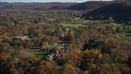 5.5K aerial stock footage of water tower and mansion in Autumn, Garrison, New York Aerial Stock Footage | AX119_162