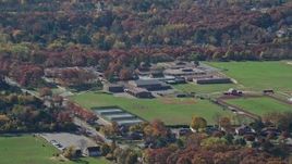 5.5K aerial stock footage of a small time high school in Autumn, Syosset, New York Aerial Stock Footage | AX119_246