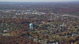 5.5K aerial stock footage of a water tower and suburban neighborhoods in Autumn, Syosset, New York Aerial Stock Footage | AX119_247