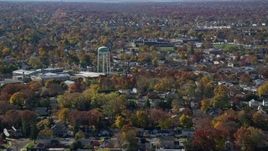 5.5K aerial stock footage of a suburban residential neighborhood and water tower in Autumn, Farmingdale, New York Aerial Stock Footage | AX119_254
