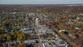 5.5K aerial stock footage orbit industrial buildings and train tracks in Autumn, Farmingdale, New York Aerial Stock Footage | AX119_255