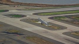 5.5K aerial stock footage of an airliner cruising down runway at JFK Airport, New York Aerial Stock Footage | AX120_054E