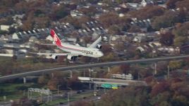 5.5K aerial stock footage of a cargo plane descending toward JFK Airport, New York in Autumn Aerial Stock Footage | AX120_060E